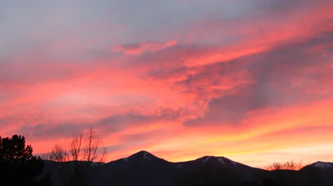 Fiery sunset through clouds over mountains Video stock 37127422