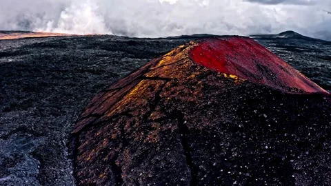Fiery volcano peak glowing with molten lava in desolate landscape. Stock Footage 341071822