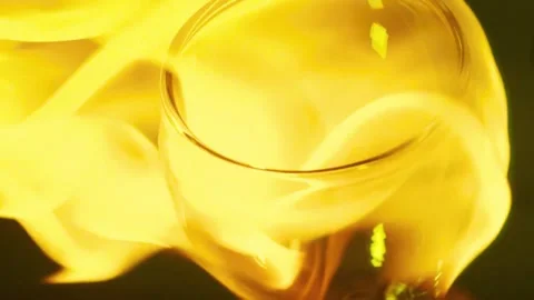 Fiery wine glass with flickering orange flames on dark backdrop clip Stock Footage 341802148