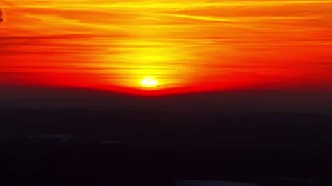 Fiery winter sunrise close-up with sun touching the horizon, intense orange Stock Footage 327806641