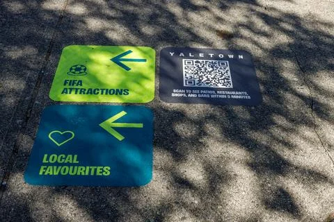 FIFA and Yaletown wayfinding decals on a Vancouver sidewalk Stock Photos