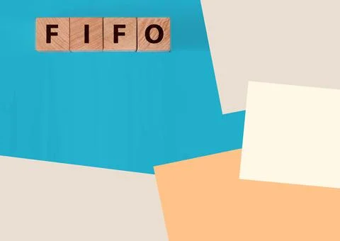 FIFO First in, first out word on wooden cubes on blue. Accounting Concept Фото