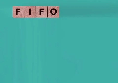 FIFO First in, first out word on wooden cubes on blue. Accounting Concept Stock Photos