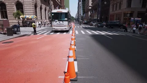 Fifth Avenue scene capturing construction cones, cyclists, buses, and people Stock Footage 342305373