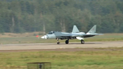 Fifth-generation fighter Su-57 taxis along  runway towards start. Close-up. Stock Footage 115394932