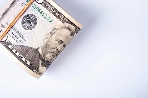 Fifty dollar bills in stack with rubberband. Stock Photos