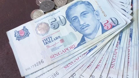 Fifty dollars note on display with many coins Stock Footage 269683526