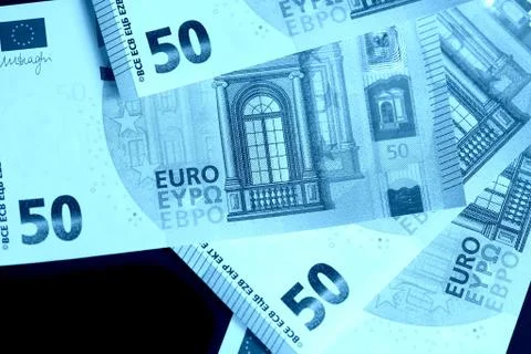 Fifty euro notes on a dark background close up. Blue color toned Foto stock