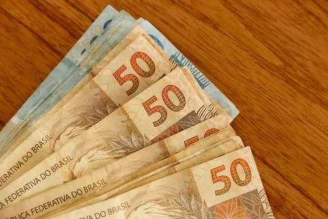Fifty real bills in focus on table with hundred real bills in background Stock Photos