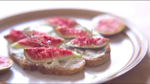 Fig appetizer being garnished with honey Stock Footage 76136398