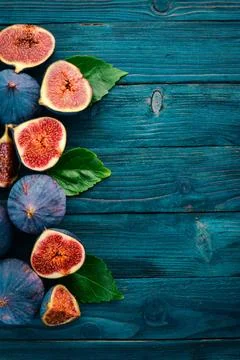 Fig. Fresh fruit figs on a blue wooden table. Free space for text. Top view. Stock Photos