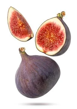 Fig half and a piece flying close-up on a white background. Isolated Fotos Stock