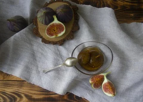 Fig marmalade with sliced figs in the rustic background Stock Photos