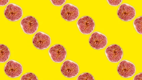 Fig slices in animated grid seamless loop pattern on a yellow background Stock Footage 222323959