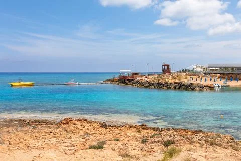 Fig Tree Bay in Cyprus with turquoise sea and rocky shoreline Stock Photos