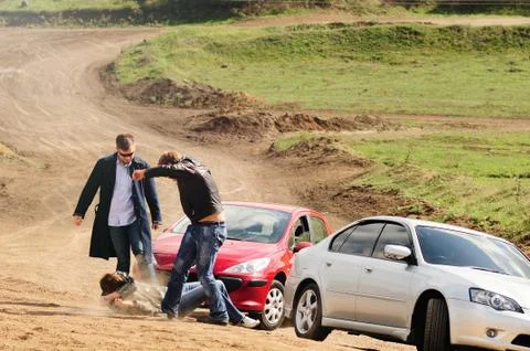 Fight on the road, two men beat the driver for violating the rules, the confl Stock Photos