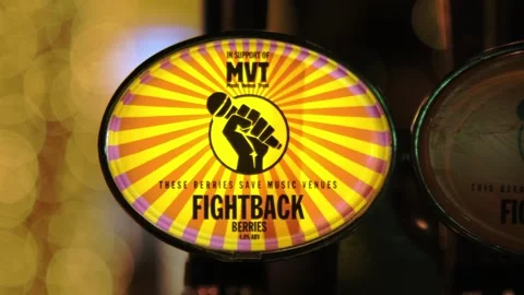 Fightback lager beer logo glowing yellow inside bar in central London. Stock Footage 253175524