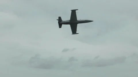 Fighter aircraft fly quickly and low, turn left against a cloudy overcast sky. Stock Footage 118677485