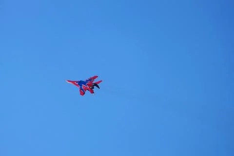 The fighter aircraft in the sky performs a demonstration flight. Stock Photos