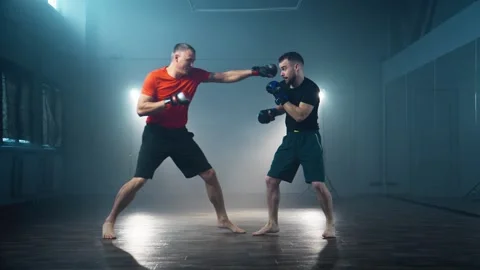 Fighter and personal trainer practicing at smoky background. Stock-Footage 279572639