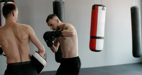 Fighter in boxer does punch in jump in slow motion, kickboxers are training in Stock Footage 160144684