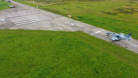 Fighter combat jet move on runway at the old aerodrome. Top view from a drone. Stock-Footage 118676409