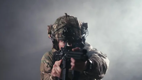 Fighter in contemporary combat gear aims weapon directly at the viewer, Stock Footage 336490841