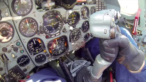 The fighter dashboard and pilot hand operating military aircraft by side stick Stock Footage 73485750