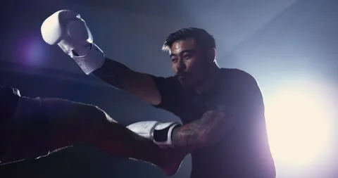 Fighter dodging leg kick inside ring match. Man wearing boxing gloves train.. Video stock 253649991