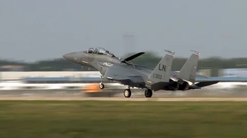 Fighter F-15 Eagle lowers nose on front landing gear at end of  runway. Stock Footage 107132723