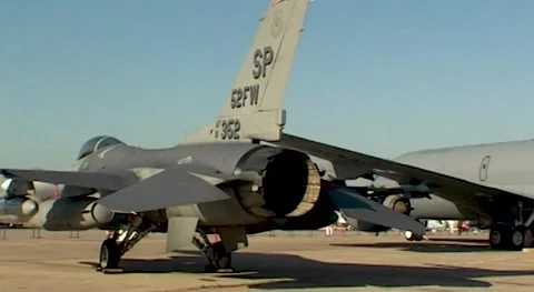 Fighter F-16 Fighting Falcon and Kc-135 refueling aircraftat parking lot Stock Footage 195471698
