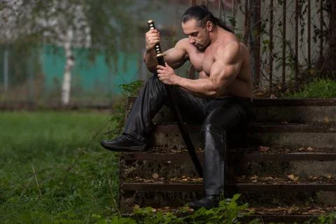 Fighter holding ancient sword Stock Photos
