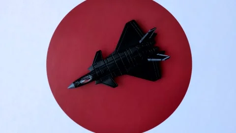 A fighter jet against the Japanese flag as a conceptual background representing  Stock Footage 337825548