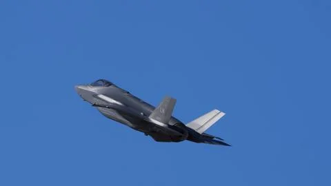 Fighter Jet in Flight with Clear Blue Sky Copy Space Stock Photos