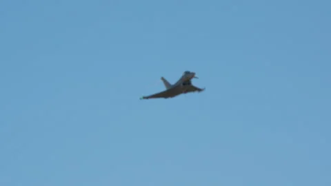 Fighter jet Maneuvering in a Clear Sky Stock Footage 334506546