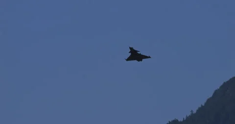 Fighter Jet Performs Parallel Flight Maneuver Against Runway in Swiss Valley Stock Footage 269501924