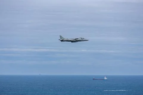 Fighter jet plane performing at air show above Atlantic ocean in Gijon, Spain 库存照片