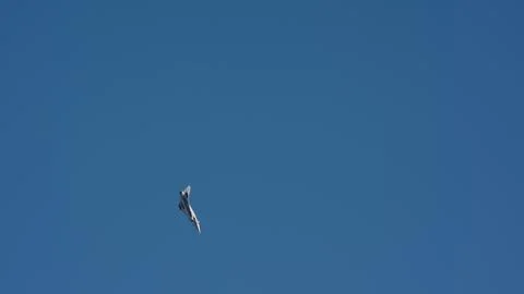 Fighter jet pulling vertical climb against clear blue sky Stock Photos