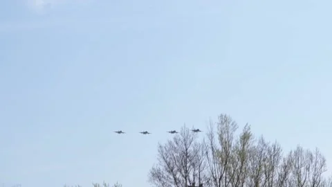 Fighter jets in the blue sky above apartment buildings. Airshow. Stock-Footage 153474105