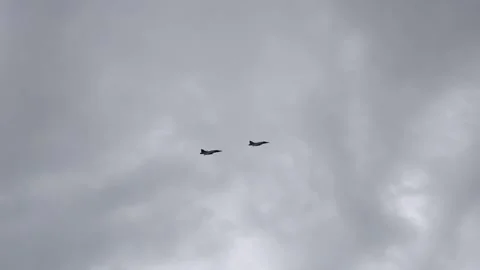 Fighter jets F16 Falcons fly close in combat formation through grey overcast sky Stock Footage 311662234