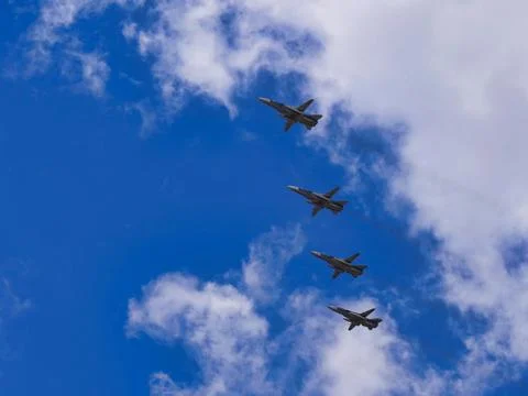 Fighter jets fly at ultra-low altitude over the city Stock Photos