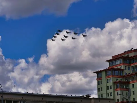 Fighter jets fly at ultra-low altitude over the city Stock Photos