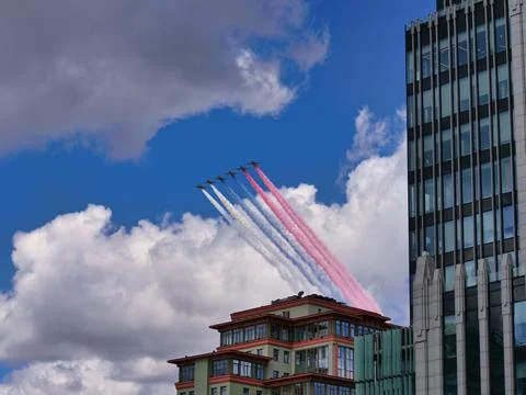 Fighter jets fly at ultra-low altitude over the city Stock Photos
