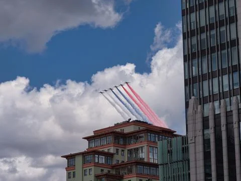 Fighter jets fly at ultra-low altitude over the city Stock Photos