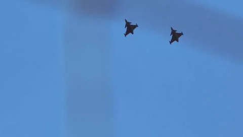 Fighter jets over wind turbines power energy contrast industrial future Stock Footage 308646808