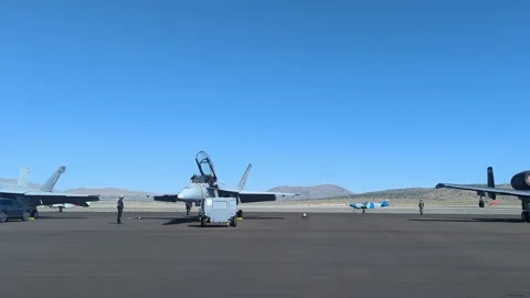 Fighter Jets Stationed on Airfield with Clear Blue Sky Stock Footage 334935879