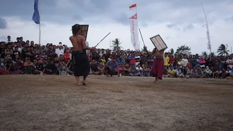 Fighter looses stick and referee tells fighters to hug at Peresean Stick Video stock 131016273