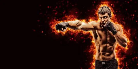 Fighter man punching in fire Stock Photos