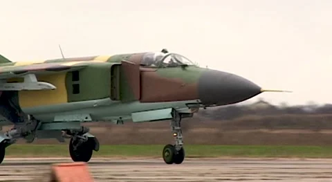 Fighter MiG-23 (NATO: Flogger) moves along  runway. Close-up. Syrian Air Force. Stock Footage 143253907