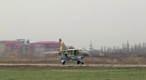 Fighter MiG-23 (NATO: Flogger) moves along taxiway towards parking lot. Close-up Stock Footage 143460939